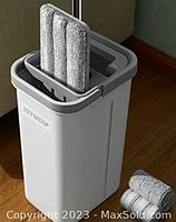 Photo of the gray plastic JOYMOOP bucket with two microfiber mop heads inserted for wringing, showing the mop handle and mop heads.