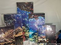 5 panels of canvas wall art showing vibrant underwater ocean scenes with coral reefs and fish.