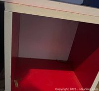 Close-up photo of one organizer showing red interior and white edges with some wear.