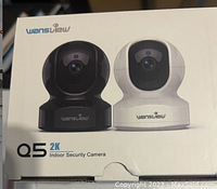 Front view of box showing both black and white Wansview Q5 2K indoor security cameras on white background.
