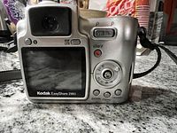 Back view of Kodak EasyShare Z650 camera showing LCD screen and control buttons including share, menu, review, and delete.