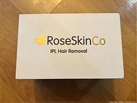 RoseSkinCo IPL Hair Removal device box with brand name and product type on lid.