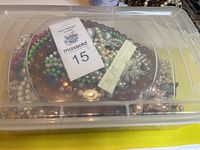 Lot of 38 vintage beaded necklaces and 1 bracelet in a clear plastic box, showing a dense pile of various bead styles and colors.