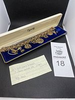 Entire 10k gold bracelet with charms in Dynasty box and handwritten note