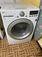 Front view of white LG front load washing machine with control panel, circular door, and detergent drawer closed.