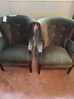 Set of two green velvet upholstered armchairs, showing overall condition and style