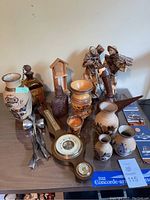 Overview photo of all items including vases, figurines, barometer, and other small decorative objects spread on a table