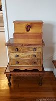 Full view of the walnut chest with three drawers and the two wooden boxes stacked on top, showing size and condition.