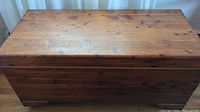 Exterior view of cedar chest showing wear and natural wood grain finish