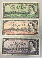Front side of $1, $2, and $10 Canadian bills from 1954 in used condition