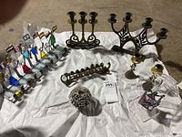 Overview of all candle holders showing variety of metal, stained glass, and acrylic pieces.