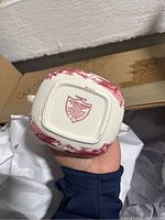 Bottom of a Meakin Tonquin ceramic creamer jug showing the maker's mark and red scenic design