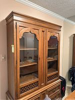 Front view of Drexel china cabinet showing glass doors with lattice panels and wooden frame.