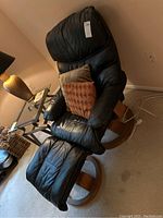 Angle view showing chair and ottoman with accent pillow