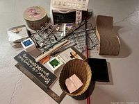 Full lot of household items including toaster oven, hat box, wire racks, wicker basket, mop, decorative sign, glass ornaments, cat scratch toy.