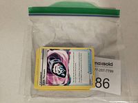 Pokemon trading cards sealed in a zip-top plastic bag with seller label underneath.