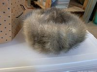 Close-up photo of the mink pill hat showing dense, soft fur with brown and gray shades.