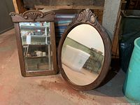 Both oak mirrors side by side on the floor showing overall shape and design.