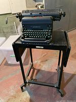 Full view of Remington Rand typewriter on the metal table stand