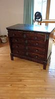 Full view of small burl wood dresser with marble top and four drawers
