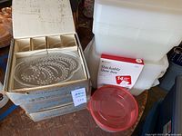 Glass snack set with Federal Glass Company box. White plastic stackable storage bins and Life Story shoe box set with imaging on box in front.