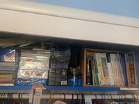 Shelf with stacks of hanging folders, Manila envelopes, and paper packages