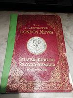 Cover of The Illustrated London News Silver Jubilee Record Number featuring embossed gold text on red cover, with green spine and minor damage
