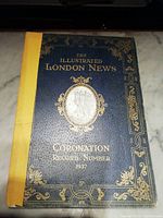 Front cover with gold embossed title and decorative design on a dark blue textured background, featuring a yellow spine tape.