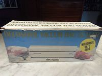 Photo of original Decosonic vacuum bag sealer box showing product with vegetables and text "Microwave Safe Bags"