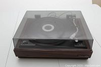 Full view of Realistic R-8000 turntable with dust cover on white background.