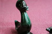 Single Blue Mountain Pottery duck showing the green glazed finish and smooth shape
