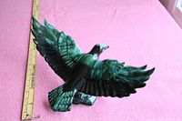 Side angled view of Blue Mountain Pottery ceramic eagle figurine with wings spread, showing detailed glaze and coloring, placed next to a measuring stick showing approximately 15 inch wingspan.