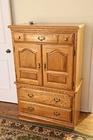 Front view of solid oak highboy dresser showing design and drawer pulls