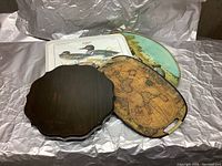 Four assorted trays stacked together showing shapes and images on trays.