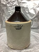 Front view of antique two-tone stoneware jug with visible crown mark.