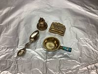 Group photo of the full set including medicine spoon, stamp box, coronation bell, and sugar bowl, showing relative sizes and arrangement on silver fabric backdrop.