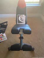 Front view of Bowflex SelectTech 5.1 adjustable workout bench with instruction manual attached to the backrest.
