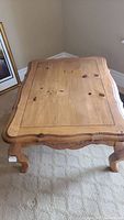 Top view of wooden rectangular coffee table showing panel design and minor surface scratches