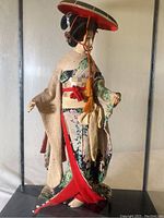 Close-up of the Japanese woman figurine showing detailed kimono and facial features.