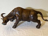 Front view of bronze water buffalo on cloth background