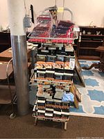 Front view of metal rack with men's briefs in boxes on the middle and bottom shelves; top shelf items excluded.