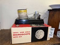 Close view of the barometer showing details of the chart recorder, cylindrical paper chart and wiring on black base.