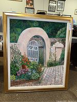 Full view of the framed painting illustrating a garden gate with plants and brick path.