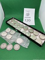 Long tray and plastic flips holding stacks of quarters