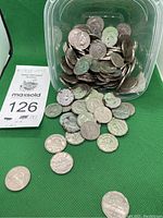 Photo of a plastic container and loose pile of Canadian nickels showing several coins with beaver and caribou designs, along with a label indicating 189 nickels from 1938 to 1973.