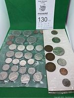 Full view of coins from 1968 uncirculated set and older 1918 and 1919 coins on green background.