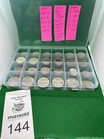 Overall view of open plastic case showing coins in compartments and pink year/count labels