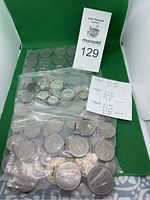 Overview of coins in sealed bags and coin holders with seller's note detailing quantity and denominations by year.
