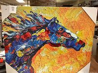 Front view of the large canvas print showing an abstract horse in vibrant primary colors on a yellow-orange background.