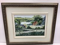 Front view of the framed painting showing the country landscape with houses, a pathway, trees, and water body.